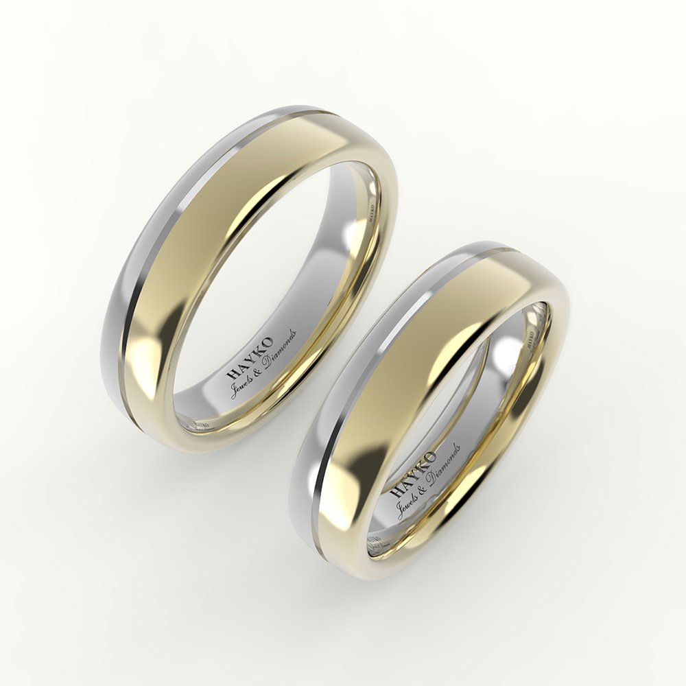 Tweedelige witgouden en gouden trouwring, met afgeronde band.