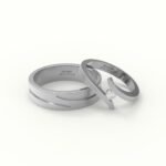 Witgouden trouwring met open design, gezet met diamant.