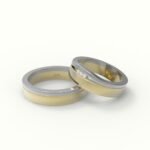 Tweedelige trouwring in goud en witgoud, gezet met drie diamanten.