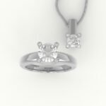 Set van witgouden hanger en solitaire verlovingsring, gezet met centrale diamant en diamanten in de pootjes.