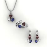 Set van asymmetrische witgouden hanger, ring en oorbellen gezet met diamant, robijn en saffier.