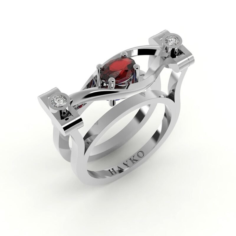 Witgouden design ring gezet met diamanten en centrale robijn.